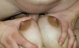 Busty brunette wife is fucked hard between her big juicy tits. She enjoys every second her husband thrust his hard cock between her breasts.